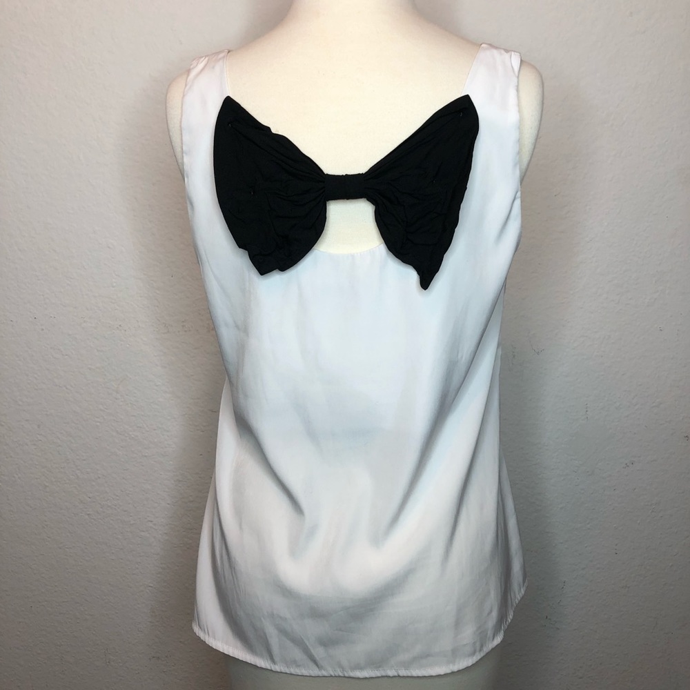White top with large black bow in back mediums